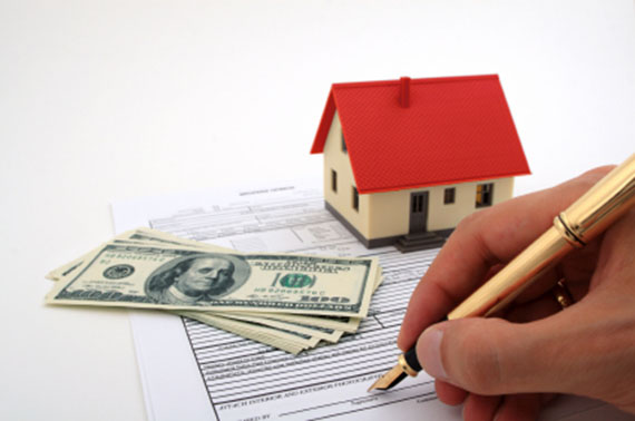 Stock image of a person signing a home loan form