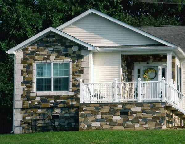A cute looking manufactured home with a faux stone exterior